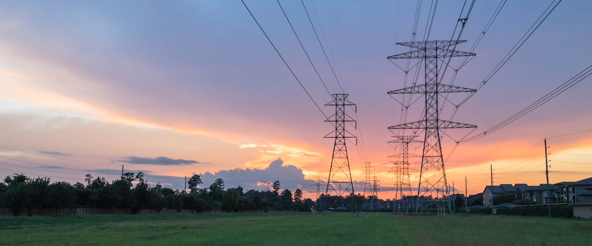Power transmission lines at sunset near Midwest town