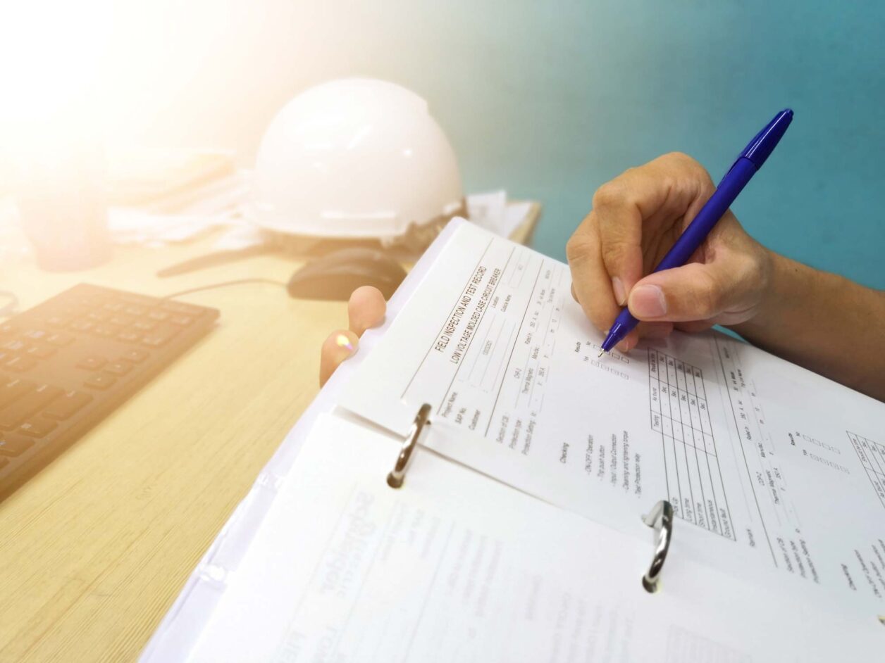 Professional electrical technician filling out a self-report
