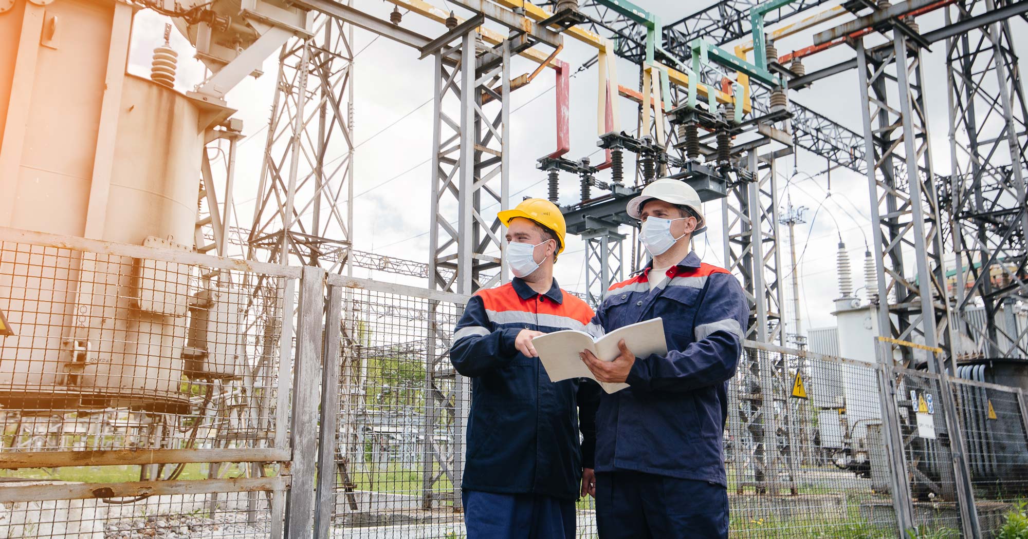 Engineers in electrical substation conducts a survey of modern high-voltage equipment