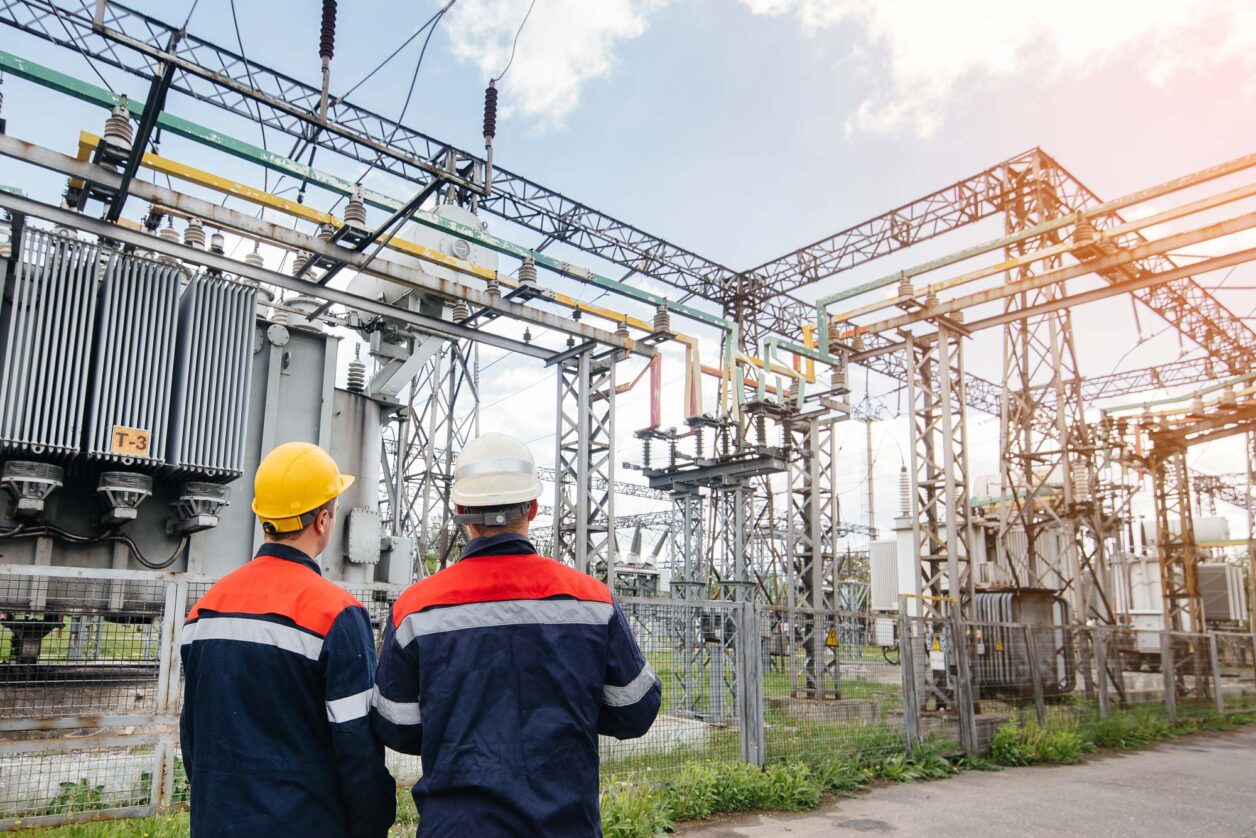Auditors completing on-site audit of electrical energy substation