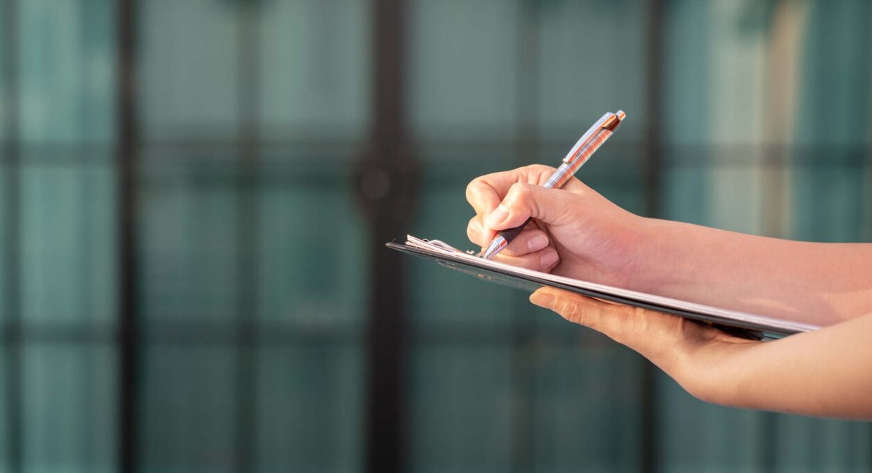 Person with clipboard completing spot check compliance audit