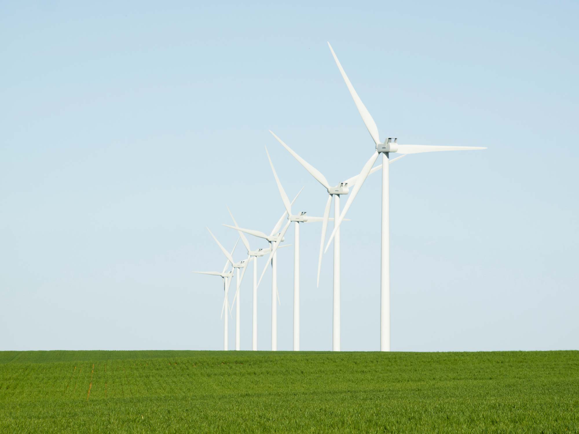 Smart rural connectivity wind turbines lined up in an agriculture field