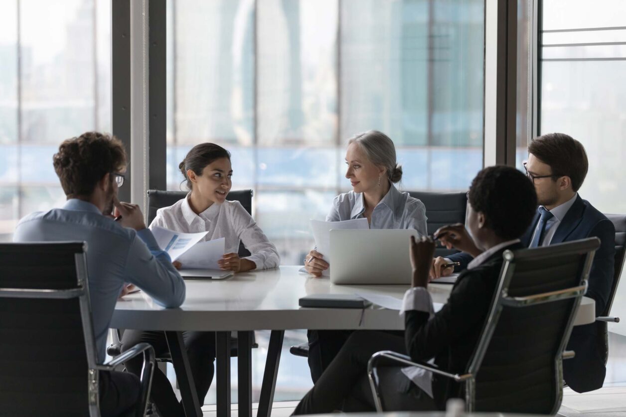 Team of professionals meeting at conference table